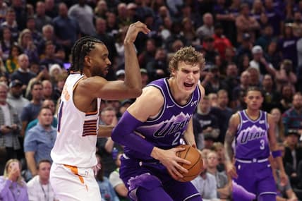 Nov 17, 2023; Salt Lake City, Utah, USA; Utah Jazz forward Lauri Markkanen (23) goes to the basket against Phoenix Suns forward Keita Bates-Diop (21) in the fourth quarter at Delta Center. Mandatory Credit: Rob Gray-USA TODAY Sports
