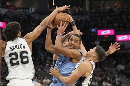 Nov 18, 2023; San Antonio, Texas, USA; Memphis Grizzlies guard Desmond Bane (22) looks to pass the ball while defended by San Antonio Spurs forwards Dom Barlow (26) and Doug McDermott (17) during the second half at Frost Bank Center. Mandatory Credit: Scott Wachter-USA TODAY Sports