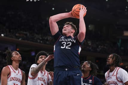 Nov 19, 2023; New York, New York, USA; Connecticut Huskies center Donovan Clingan (32) goes to the basket in front of Indiana Hoosiers center Kel'el Ware (1) and forward Mackenzie Mgbako (21) and guard Gabe Cupps (2) during the first half at Madison Square Garden. Mandatory Credit: Vincent Carchietta-USA TODAY Sports