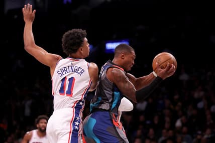 Nov 19, 2023; Brooklyn, New York, USA; Brooklyn Nets guard Lonnie Walker IV (8) grabs a rebound against Philadelphia 76ers guard Jaden Springer (11) during the first quarter at Barclays Center. Mandatory Credit: Brad Penner-USA TODAY Sports