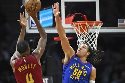 Nov 19, 2023; Cleveland, Ohio, USA; Cleveland Cavaliers forward Evan Mobley (4) shoots beside Denver Nuggets forward Aaron Gordon (50) in the second quarter at Rocket Mortgage FieldHouse. Mandatory Credit: David Richard-USA TODAY Sports