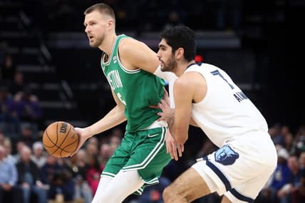 Nov 19, 2023; Memphis, Tennessee, USA; Boston Celtics center Kristaps Porzingis (8) passes as Memphis Grizzlies forward-center Santi Aldama (7) defends during the first half at FedExForum. Mandatory Credit: Petre Thomas-USA TODAY Sports
