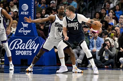 Nov 19, 2023; Dallas, Texas, USA; Dallas Mavericks guard Luka Doncic (77) looks to move the ball past Sacramento Kings forward Harrison Barnes (40) during the second half at the American Airlines Center. Mandatory Credit: Jerome Miron-USA TODAY Sports