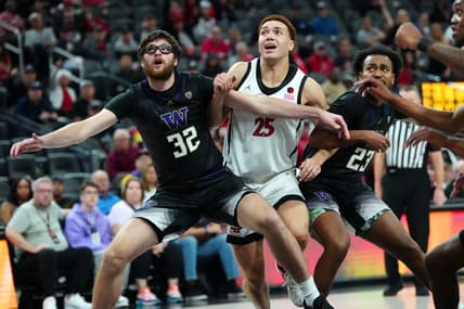 Nov 19, 2023; Las Vegas, NV, USA; San Diego State Aztecs forward Elijah Saunders (25) is blocked out by Washington Huskies forward Wilhelm Breidenbach (32) and guard Anthony Holland (23) during the first half at T-Mobile Arena. Mandatory Credit: Stephen R. Sylvanie-USA TODAY Sports