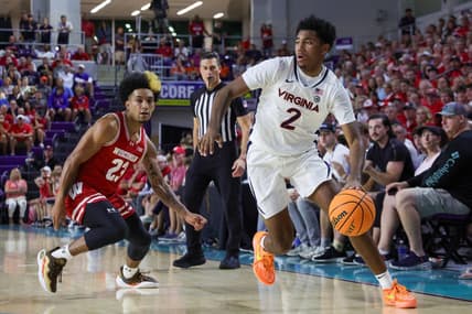Nov 20, 2023; Fort Myers, Florida, USA;  Virginia Cavaliers guard Reece Beekman (2) moves the ball past Wisconsin Badgers guard Chucky Hepburn (23) in the first half during the Fort Myers Top-Off at Suncoast Credit Union Arena. Mandatory Credit: Nathan Ray Seebeck-USA TODAY Sports
