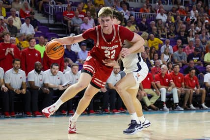 Nov 20, 2023; Fort Myers, Florida, USA;  Wisconsin Badgers forward Steven Crowl (22) drives to the basket past Virginia Cavaliers forward Blake Buchanan (0) in the second half during the Fort Myers Top-Off at Suncoast Credit Union Arena. Mandatory Credit: Nathan Ray Seebeck-USA TODAY Sports