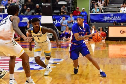 Nov 21, 2023; Honolulu, HI, USA; Kansas Jayhawks guard Dajuan Harris Jr. (3) drives the ball downcourt against Marquette Golden Eagles guard Kam Jones (1) and David Joplin (23) during the first period at SimpliFi Arena at Stan Sheriff Center. Mandatory Credit: Steven Erler-USA TODAY Sports