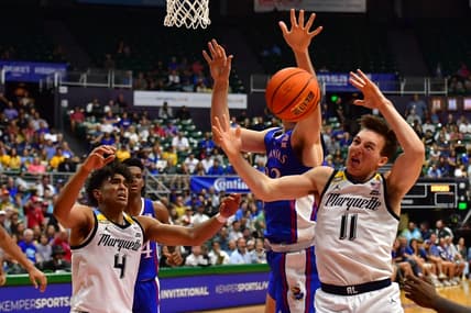 Nov 21, 2023; Honolulu, HI, USA; Kansas Jayhawks forward Parker Braun (23) fought for a rebound with Marquette Golden Eagles guard Stevie Mitchell (4) and guard Tyler Kolek (11) during the first period at SimpliFi Arena at Stan Sheriff Center. Mandatory Credit: Steven Erler-USA TODAY Sports