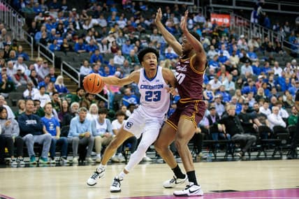 Nov 22, 2023; Kansas City, Missouri, USA; Creighton Bluejays guard Trey Alexander (23) drives around Loyola (Il) Ramblers forward Patrick Mwamba (30) during the first half at T-Mobile Center. Mandatory Credit: William Purnell-USA TODAY Sports