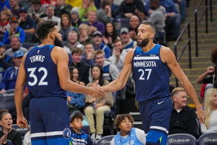 Nov 22, 2023; Minneapolis, Minnesota, USA; Minnesota Timberwolves center Karl-Anthony Towns (32) congratulates center Rudy Gobert (27) against the Philadelphia 76ers in the third quarter at Target Center. Mandatory Credit: Brad Rempel-USA TODAY Sports