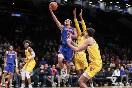 Nov 22, 2023; Brooklyn, New York, USA; Florida Gators guard Walter Clayton Jr. (1) drives past Pittsburgh Panthers guard Carlton Carrington (7) for a layup in the second half at Barclays Center. Mandatory Credit: Wendell Cruz-USA TODAY Sports