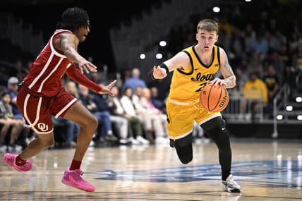 Nov 23, 2023; La Jolla, California, USA; Iowa Hawkeyes guard Brock Harding (2) dribbles the ball while defended by Oklahoma Sooners guard Javian McCollum (2) during the first half at LionTree Arena. Mandatory Credit: Orlando Ramirez-USA TODAY Sports