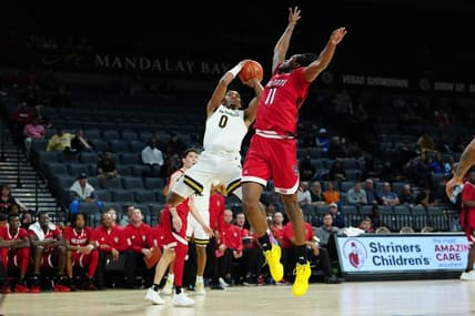 Nov 23, 2023; Las Vegas, Nevada, USA; Vanderbilt Commodores guard Tyrin Lawrence (0) shoots against North Carolina State Wolfpack guard Dennis Parker Jr. (11) during the first half at Michelob Ultra Arena. Mandatory Credit: Stephen R. Sylvanie-USA TODAY Sports