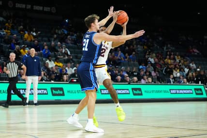 Nov 23, 2023; Las Vegas, Nevada, USA; Brigham Young Cougars guard Trevin Knell (21) defends against Arizona State Sun Devils guard Jose Perez (12) during the first half at Michelob Ultra Arena. Mandatory Credit: Stephen R. Sylvanie-USA TODAY Sports