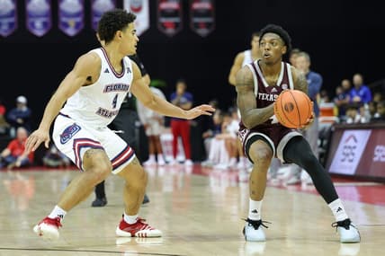 Nov 24, 2023; Kissimmee, FL, USA;  Texas A&M Aggies guard Wade Taylor IV (4) looks to shoot the ball guarded by Florida Atlantic Owls guard Bryan Greenlee (4) in the second half during the ESPN Events Invitational Semifinals at State Farm Field House. Mandatory Credit: Nathan Ray Seebeck-USA TODAY Sports