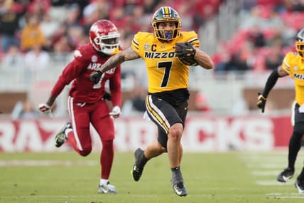 Nov 24, 2023; Fayetteville, Arkansas, USA; Missouri Tigers running back Cody Schrader (7) rushes against the Arkansas Razorbacks during the second quarter at Donald W. Reynolds Razorback Stadium. Mandatory Credit: Nelson Chenault-USA TODAY Sports
