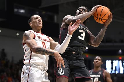 Nov 24, 2023; La Jolla, California, USA; Oklahoma Sooners guard Otega Oweh (3) goes to the basket while defended by USC Trojans guard Kobe Johnson (0) during the second half at LionTree Arena. Mandatory Credit: Orlando Ramirez-USA TODAY Sports
