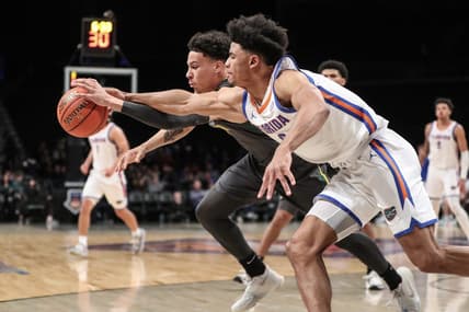 Nov 24, 2023; Brooklyn, NY, USA;  Florida Gators guard Zyon Pullin (0) and Baylor Bears guard Miro Little (1) fight for a loose ball in the first half at Barclay Center. Mandatory Credit: Wendell Cruz-USA TODAY Sports
