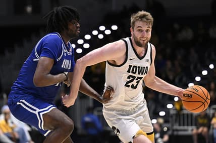 Nov 24, 2023; La Jolla, California, USA; Iowa Hawkeyes forward Ben Krikke (23) dribbles the ball while defended by Seton Hall Pirates center Jaden Bediako (15) during the first half at LionTree Arena. Mandatory Credit: Orlando Ramirez-USA TODAY Sports