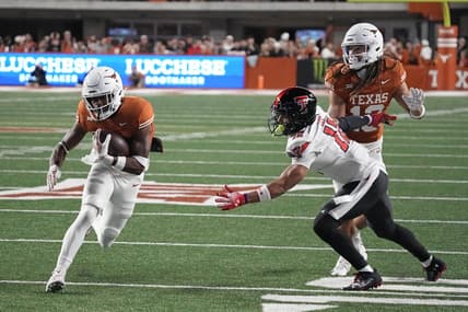 Nov 24, 2023; Austin, Texas, USA; Texas Longhorns running back Keilan Robinson (7) runs for a touchdown while defended by Texas Tech Red Raiders defensive back Bralyn Lux (12) during the first half at Darrell K Royal-Texas Memorial Stadium. Mandatory Credit: Scott Wachter-USA TODAY Sports