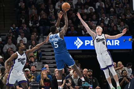 Nov 24, 2023; Minneapolis, Minnesota, USA; Sacramento Kings forward Harrison Barnes (40) and guard Kevin Huerter (9) defend the shot of Minnesota Timberwolves guard Anthony Edwards (5) during the first quarter at Target Center. Mandatory Credit: Jeffrey Becker-USA TODAY Sports