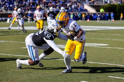Nov 25, 2023; Durham, North Carolina, USA; Duke Blue Devils linebacker Tre Freeman (12) tacks Pittsburgh Panthers running back C'Bo Flemister (24) during the first half of the game at Wallace Wade Stadium. Mandatory Credit: Jaylynn Nash-USA TODAY Sports