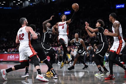 Nov 25, 2023; Brooklyn, New York, USA; Miami Heat guard Josh Richardson (0) drives to the basket against Brooklyn Nets forward Dorian Finney-Smith (28) and  guard Lonnie Walker IV (8) and forward Cameron Johnson (2) during the second quarter at Barclays Center. Mandatory Credit: John Jones-USA TODAY Sports