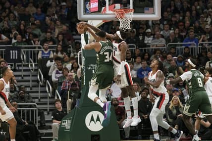Nov 26, 2023; Milwaukee, Wisconsin, USA;  Portland Trail Blazers forward Jerami Grant (9) defends Milwaukee Bucks forward Giannis Antetokounmpo (34) during the fourth quarter at Fiserv Forum. Mandatory Credit: Jeff Hanisch-USA TODAY Sports