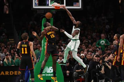 Nov 26, 2023; Boston, Massachusetts, USA; Boston Celtics guard Jaylen Brown (7) dunks over Atlanta Hawks center Clint Capela (15) during the second quarter at TD Garden. Mandatory Credit: Winslow Townson-USA TODAY Sports