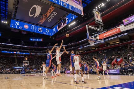 Nov 27, 2023; Detroit, Michigan, USA; Washington Wizards forward Corey Kispert (24) shoots the ball between Detroit Pistons guard Cade Cunningham (2) and guard Killian Hayes (7) during the second half at Little Caesars Arena. Mandatory Credit: David Reginek-USA TODAY Sports