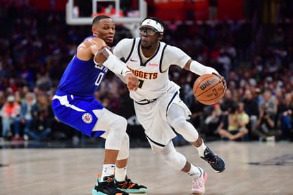 Nov 27, 2023; Los Angeles, California, USA; Denver Nuggets guard Reggie Jackson (7) moves the ball against Los Angeles Clippers guard Russell Westbrook (0) during the second half at Crypto.com Arena. Mandatory Credit: Gary A. Vasquez-USA TODAY Sports