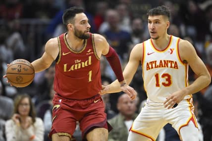 Nov 28, 2023; Cleveland, Ohio, USA; Atlanta Hawks guard Bogdan Bogdanovic (13) defends Cleveland Cavaliers guard Max Strus (1) in the second quarter at Rocket Mortgage FieldHouse. Mandatory Credit: David Richard-USA TODAY Sports