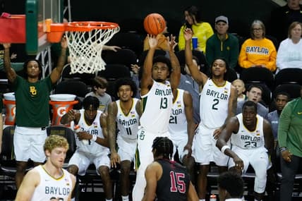 Nov 28, 2023; Waco, Texas, USA; Baylor Bears guard Langston Love (13) scores a three-point basket against Nicholls State Colonels forward Jamal West Jr. (15) during the second half at Ferrell Center. Mandatory Credit: Chris Jones-USA TODAY Sports