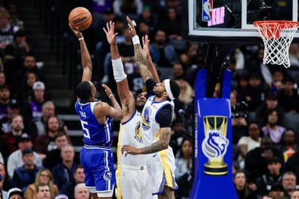 Nov 28, 2023; Sacramento, California, USA; Sacramento Kings guard De'Aaron Fox (5) shoots over Golden State Warriors guard Gary Payton II (0) during the third  quarter at Golden 1 Center. Mandatory Credit: Sergio Estrada-USA TODAY Sports