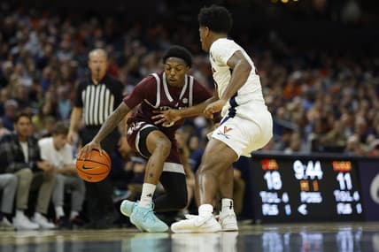 Nov 29, 2023; Charlottesville, Virginia, USA;  Texas A&M Aggies guard Wade Taylor IV (4) dribbles the ball as Virginia Cavaliers guard Reece Beekman (2) defends in the first half at John Paul Jones Arena. Mandatory Credit: Geoff Burke-USA TODAY Sports