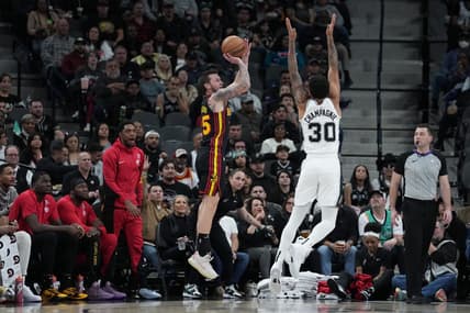 Nov 30, 2023; San Antonio, Texas, USA;  Atlanta Hawks guard Garrison Mathews (25) shoots over San Antonio Spurs forward Julian Champagnie (30) in the first half at the Frost Bank Center. Mandatory Credit: Daniel Dunn-USA TODAY Sports