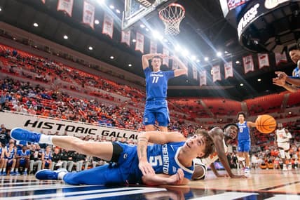 Nov 30, 2023; Stillwater, Oklahoma, USA; Oklahoma State Cowboys forward Eric Dailey Jr. (2) and Creighton Bluejays guard Francisco Farabello (5) dive after a loose ball during the first half at Gallagher-Iba Arena. Mandatory Credit: William Purnell-USA TODAY Sports
