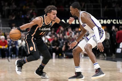 Nov 23, 2022; Atlanta, Georgia, USA; Atlanta Hawks guard Trae Young (11) dribbles against Sacramento Kings guard De'Aaron Fox (5) during the second half at State Farm Arena. Mandatory Credit: Dale Zanine-USA TODAY Sports