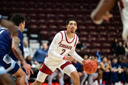 Nov 19, 2023; Uncasville, CT, USA; Washington State Cougars guard Myles Rice (2) dribbles the ball defended by Rhode Island Rams guard Luis Kortright (1) during the second half at Mohegan Sun Arena. Mandatory Credit: Mark Smith-USA TODAY Sports