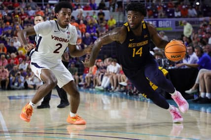 Nov 22, 2023; Fort Myers, FL, USA;  West Virginia Mountaineers guard Seth Wilson (14) drives past Virginia Cavaliers guard Reece Beekman (2) in the second half during the Fort Myers Tip-Off third place game at Suncoast Credit Union Arena. Mandatory Credit: Nathan Ray Seebeck-USA TODAY Sports