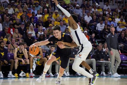 Nov 22, 2023; Fort Myers, FL, USA;  West Virginia Mountaineers forward Quinn Slazinski (11) drives to the hoop past Virginia Cavaliers guard Ryan Dunn (13) in the second half during the Fort Myers Tip-Off third place game at Suncoast Credit Union Arena. Mandatory Credit: Nathan Ray Seebeck-USA TODAY Sports