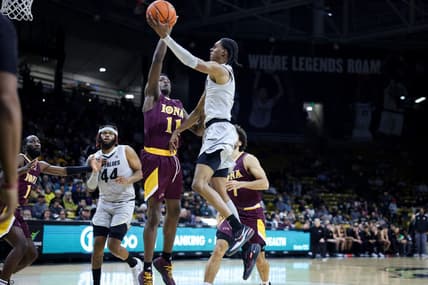 Nov 26, 2023; Boulder, Colorado, USA; Colorado Buffaloes forward Cody Williams (10) goes to the basket against Iona Gaels forward Sultan Adewale (11) during the second half at CU Events Center. Mandatory Credit: Chet Strange-USA TODAY Sports
