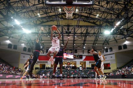 Nov 26, 2023; Kissimmee, FL, USA;  Virginia Tech Hokies guard MJ Collins (2) shoots the ball over Florida Atlantic Owls guard Johnell Davis (1) in the second half during the ESPN Events Invitational Championship game at State Farm Field House. Mandatory Credit: Nathan Ray Seebeck-USA TODAY Sports