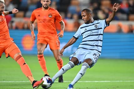Nov 26, 2023; Houston, Texas, USA; Sporting Kansas City midfielder Gadi Kinda (10) shoots the ball against Houston Dynamo midfielder Hector Herrera (16) during the first half for the MLS Cup Western Conference Semifinal match at Shell Energy Stadium. Mandatory Credit: Maria Lysaker-USA TODAY Sports