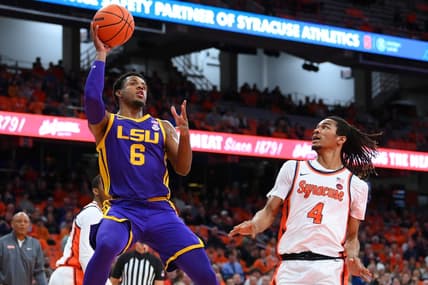 Nov 28, 2023; Syracuse, New York, USA; LSU Tigers guard Jordan Wright (6) shoots the ball as Syracuse Orange forward Chris Bell (4) defends during the first half at the JMA Wireless Dome. Mandatory Credit: Rich Barnes-USA TODAY Sports