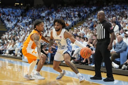Nov 29, 2023; Chapel Hill, North Carolina, USA; North Carolina Tar Heels guard RJ Davis (4) with the ball as Tennessee Volunteers guard Zakai Zeigler (5) defends in the second half at Dean E. Smith Center. Mandatory Credit: Bob Donnan-USA TODAY Sports