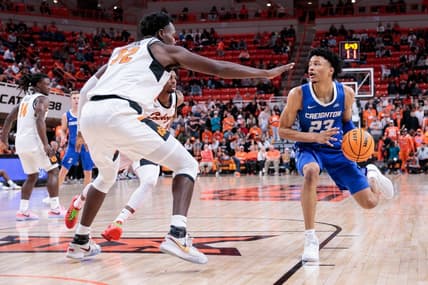 Nov 30, 2023; Stillwater, Oklahoma, USA; Creighton Bluejays guard Trey Alexander (23) drives to the basket around Oklahoma State Cowboys center Mike Marsh (32) during the second half at Gallagher-Iba Arena. Mandatory Credit: William Purnell-USA TODAY Sports