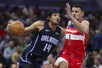 Dec 1, 2023; Orlando, Florida, USA;  Orlando Magic guard Gary Harris (14) drives to the basket past Washington Wizards guard Johnny Davis (1) in the second quarter at Amway Center. Mandatory Credit: Nathan Ray Seebeck-USA TODAY Sports