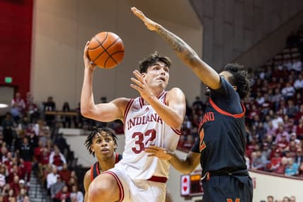 Dec 1, 2023; Bloomington, Indiana, USA; Indiana Hoosiers guard Trey Galloway (32) shoots the ball while Maryland Terrapins guard Jahari Long (2) defends in the first half at Simon Skjodt Assembly Hall. Mandatory Credit: Trevor Ruszkowski-USA TODAY Sports
