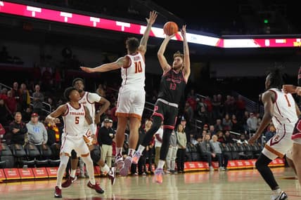 Nov 29, 2023; Los Angeles, California, USA; Eastern Washington Eagles guard Jake Kyman (13) shoots the ball against Southern California Trojans forward DJ Rodman (10)  in the first half at Galen Center. Mandatory Credit: Kirby Lee-USA TODAY Sports